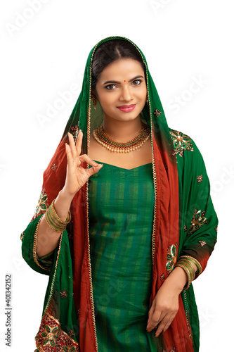 Pretty Indian young girl showing best hand sign.