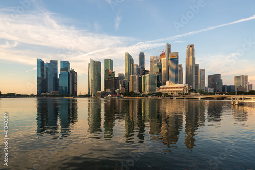 Ultra wide panorama image of Singapore skyscrapers illuminated by morning sunlight early in the morning.