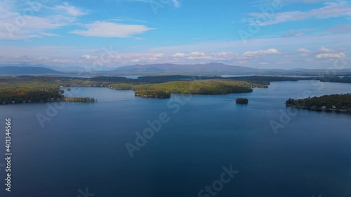 Lake Winnipesaukee and village of Weirs Beach aerial view with fall foliage in City of Laconia, New Hampshire, USA.  photo