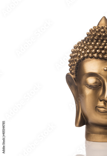 Brass Buddha head isolated on white. © krishna