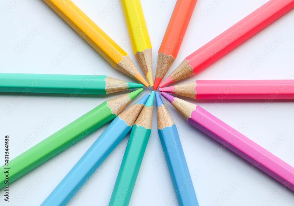 Color pencils on the white background in spinning wheel arrangement Color pencils on the white background in spinning wheel arrangement