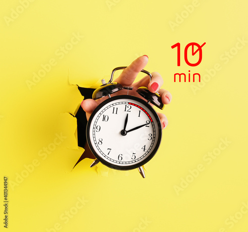Female hand holding alarm c...