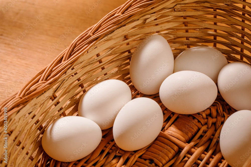 wooden basket with eggs studio shot.