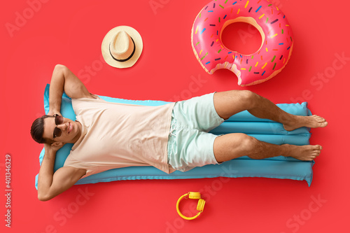 Young man lying on inflatab...