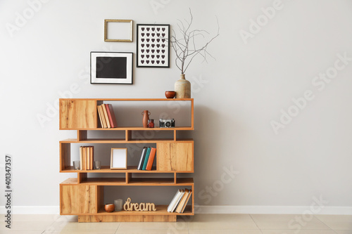 Shelving unit with books and decor in interior of room photo