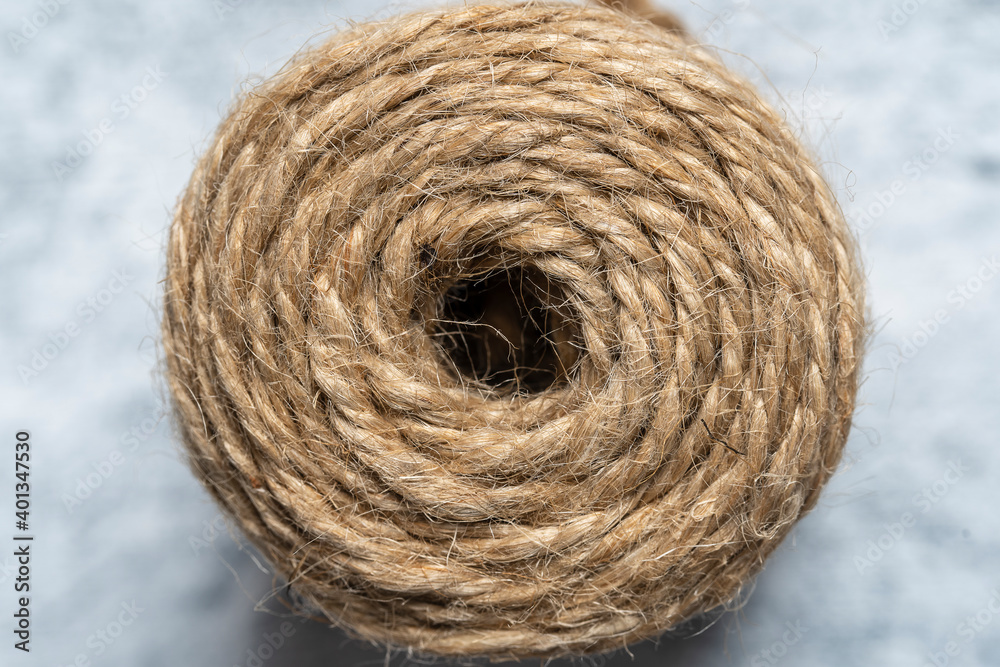 High-quality handmade coil made of natural hemp rope, isolated on a white background. Rustic beige cord made of eco material High-quality handmade coil made of natural hemp rope, isolated on a white background. Rustic beige cord made of eco material