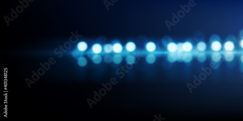 Abstract light background. Blue bokeh glow. Glittering lights reflecting on shiny surface