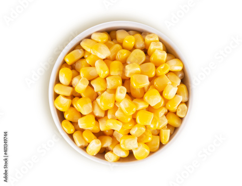 Canned corn in white bowl isolated on white background, top view