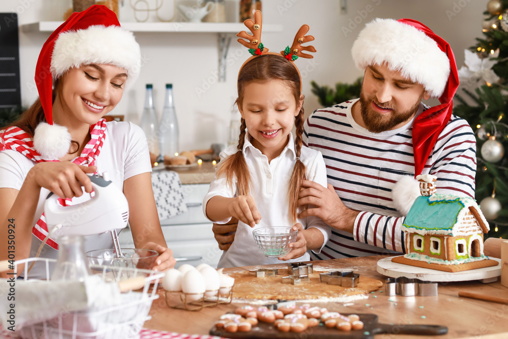Happy family making tasty gingerbread cookies in kitchen on Christmas eve Happy family making tasty gingerbread cookies in kitchen on Christmas eve