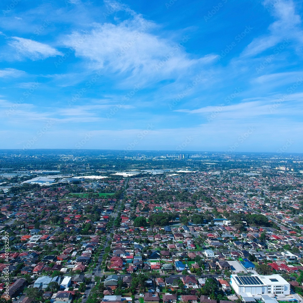 Panoramic Aerial View of Sydney Western suburbs showing house roof tops roads cars and other buildings 