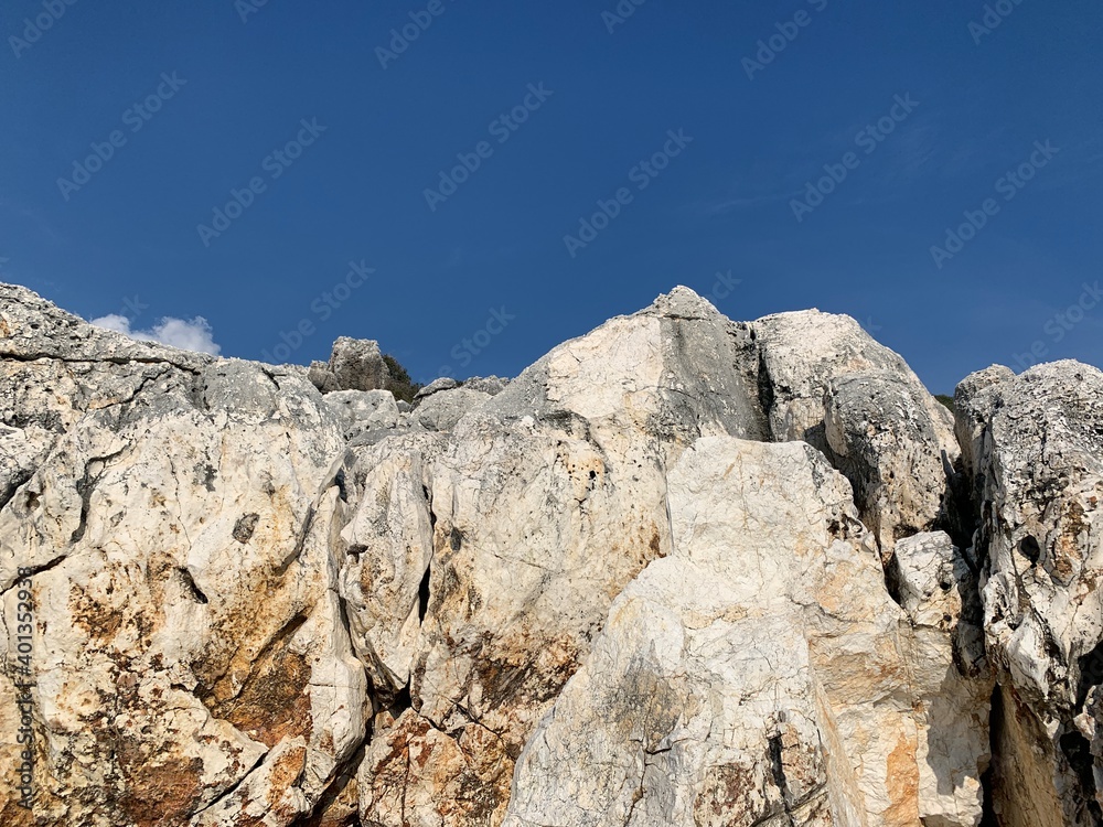 Rocky sea stones in the blue sky background, coast