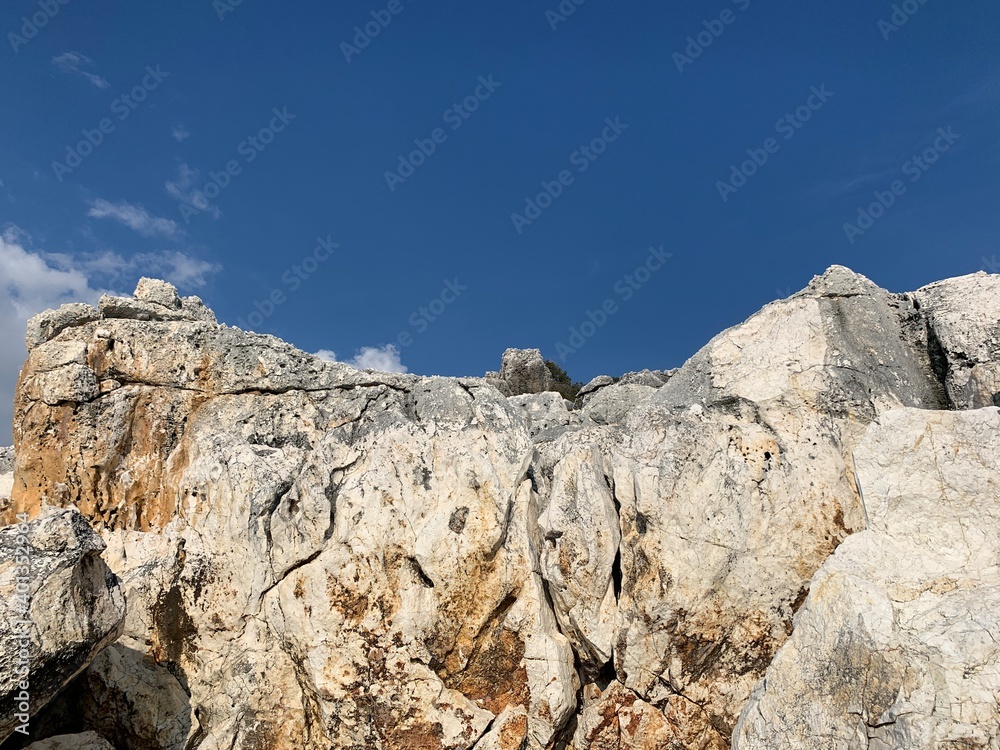 Rocky sea stones in the blue sky background, coast