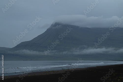 Foggy mountain and dark ocean.