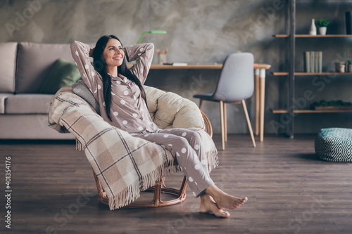 Fototapeta Naklejka Na Ścianę i Meble -  Full size photo of young happy positive good mood lovely dreamy girl look copyspace sit armchair enjoying free time at home house