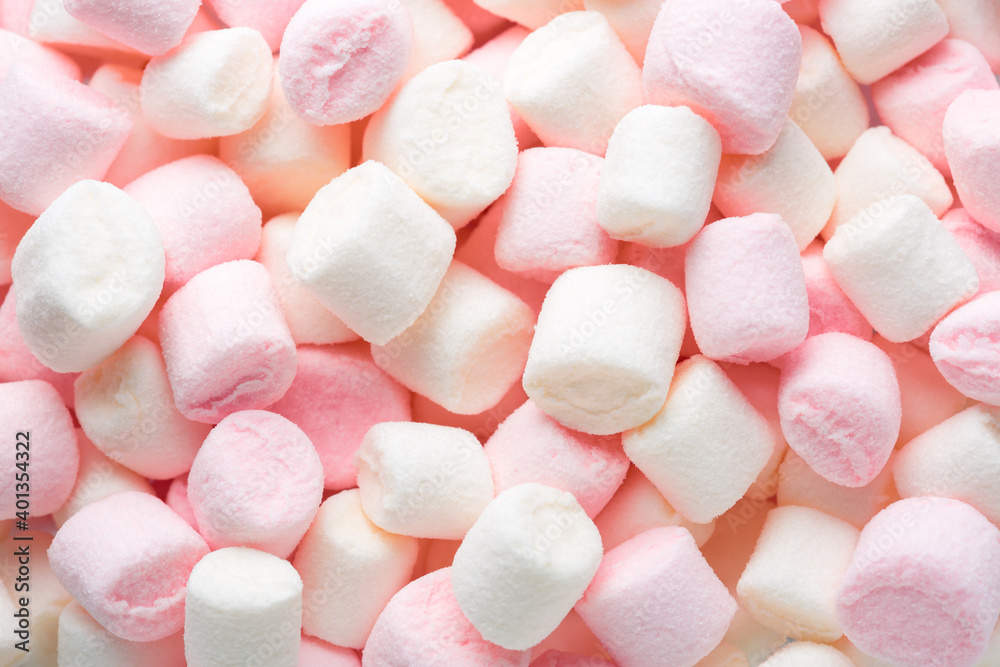 Mini marshmallows of white and light pink colors. Selective Focus. Top view. Mini marshmallows of white and light pink colors. Selective Focus. Top view.