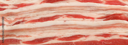 Tasty raw bacon on whole background, close up photo