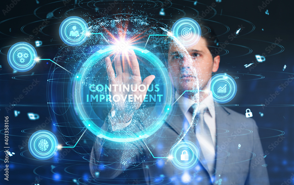 The concept of business, technology, the Internet and the network. A young entrepreneur working on a virtual screen of the future and sees the inscription: Continuous improvement The concept of business, technology, the Internet and the network. A young entrepreneur working on a virtual screen of the future and sees the inscription: Continuous improvement