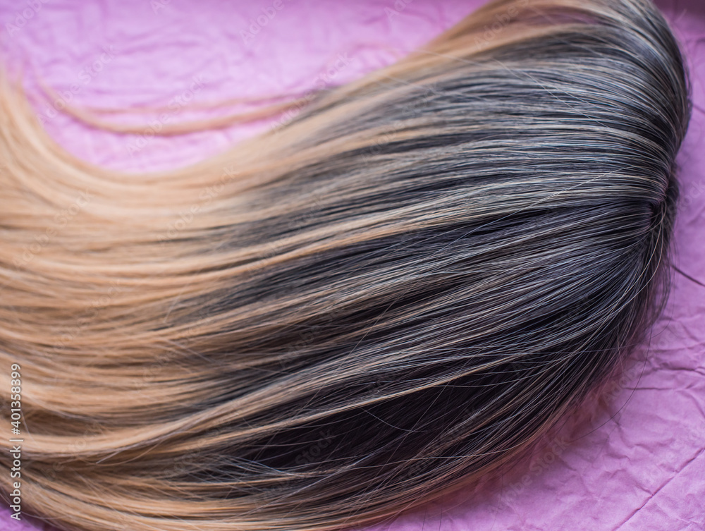 Fototapeta premium Wigs, natural and synthetic hair. Women's beauty concept. Close up photo of wig, hair for ladies