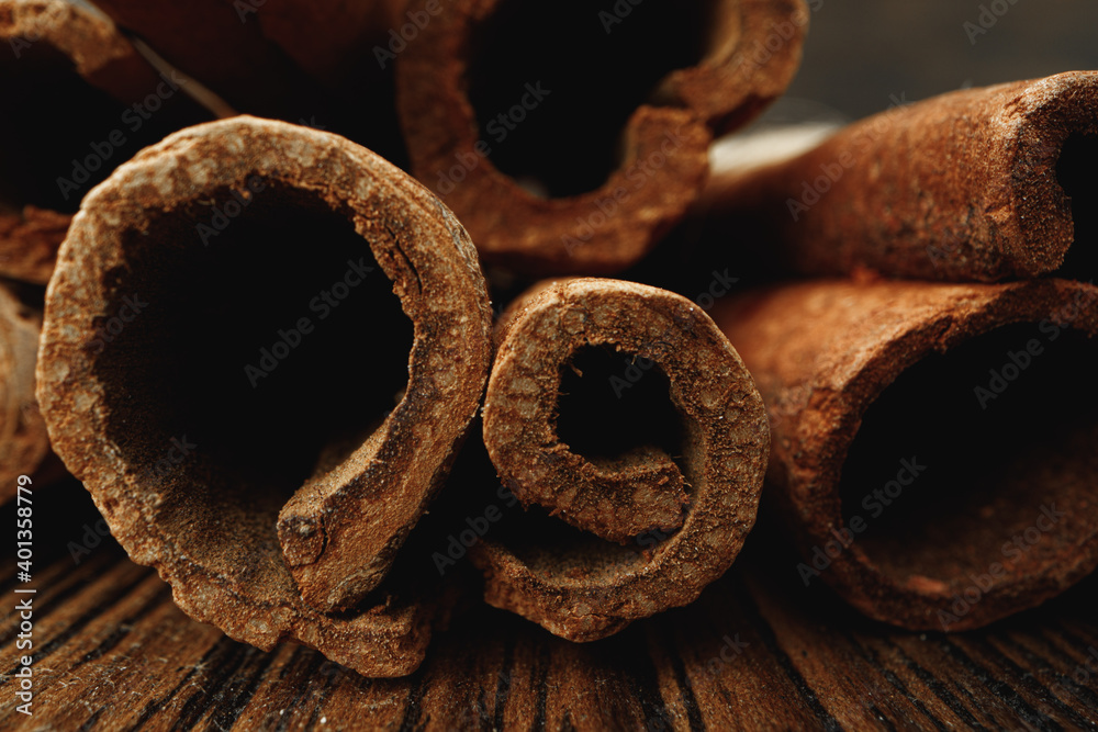 Macro photo of cinnamon sticks on wooden background Macro photo of cinnamon sticks on wooden background