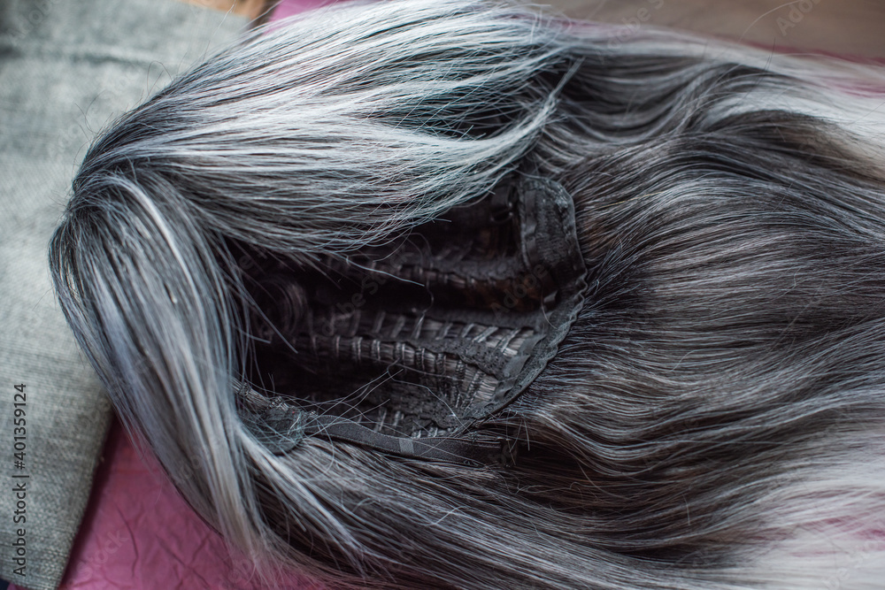 Naklejka premium Wigs, natural and synthetic hair. Women's beauty concept. Close up photo of wig, hair for ladies