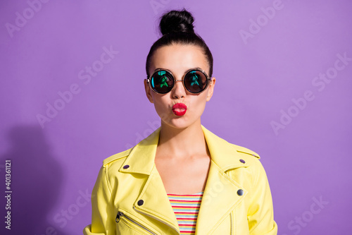 Portrait of lovely youngster girl send air kiss in camera isolated over purple color background © deagreez