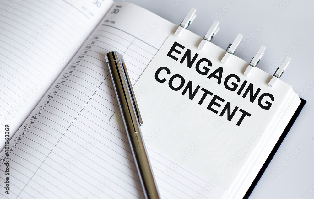 text ENGAGING CONTENT on the short note texture background with pen. Business concept text ENGAGING CONTENT on the short note texture background with pen. Business concept