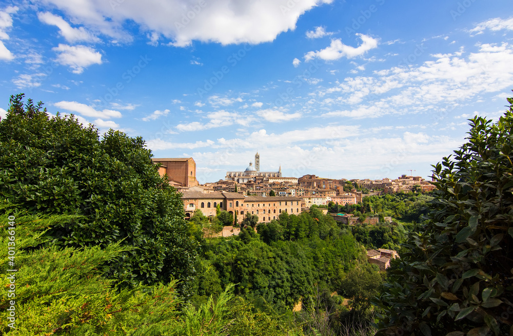 Aerial view over Siena on the dome and bell tower of Siena Cathedral and the old town of the medieval city of Siena on a sunny day, Tuscany, Italy
