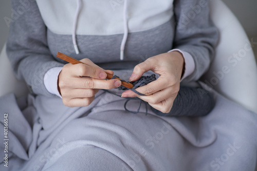 close-up of female hands knitting crochet. Photo of handwork