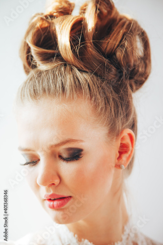 Beautiful young bride with wedding makeup and hairstyle. Closeup portrait of young gorgeous bride. Wedding.