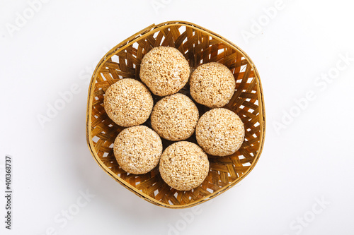 Indian sweet for traditional festival makar sankranti :Rajgira laddu made from Amaranth seed in Bowl on white background photo