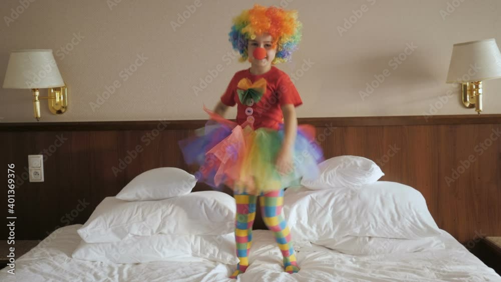 Happy Clown Little Girl Dancing And Have Fun In the Bedroom. Little Child Clown Enjoying Dance