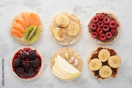 Top view rice cakes with various topping on a wooden background photo