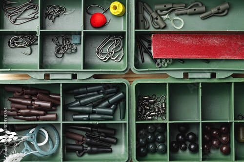 фотографія Plastic compartment case and fishing tackle top view