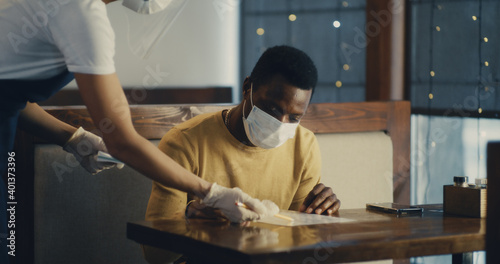 Crop woman serving black client during pandemic © Framestock