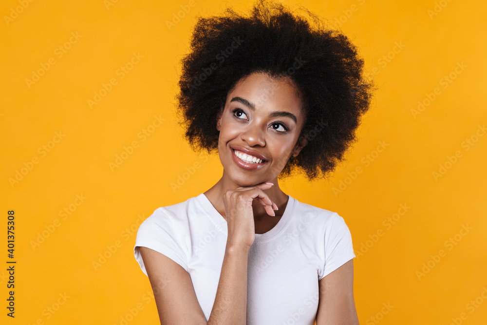 Happy african american girl smiling and looking aside Happy african american girl smiling and looking aside