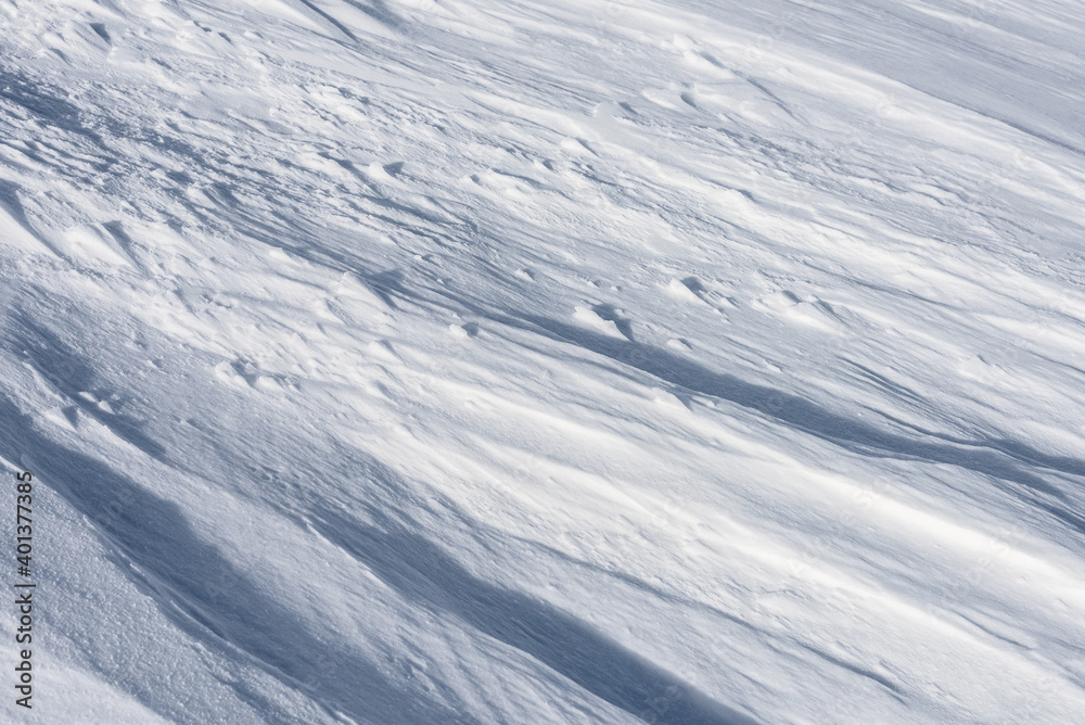 Snow surface with wind traces.Winter background. Snow surface with wind traces.Winter background.