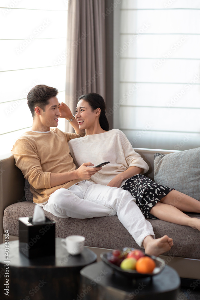 Happy young couple relaxing in living room Happy young couple relaxing in living room