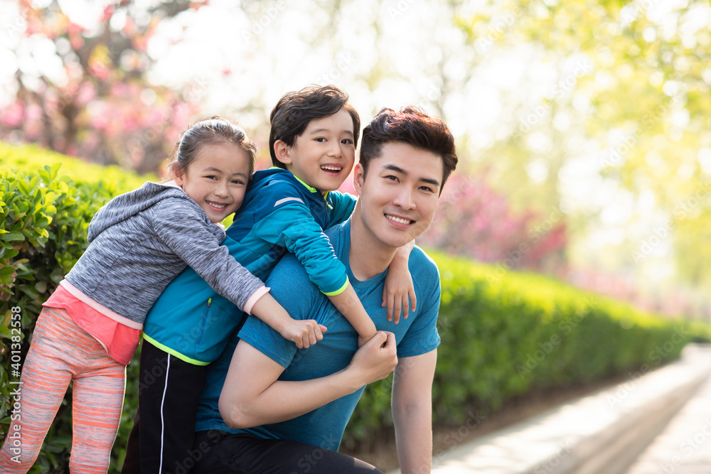 Happy young family playing in park Happy young family playing in park