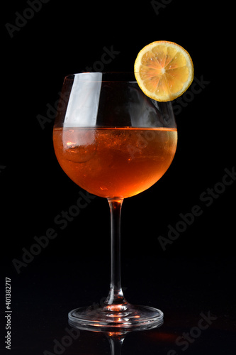 drinks in glass and glass with lemon, red berries and strawberries with shaker in elegant background