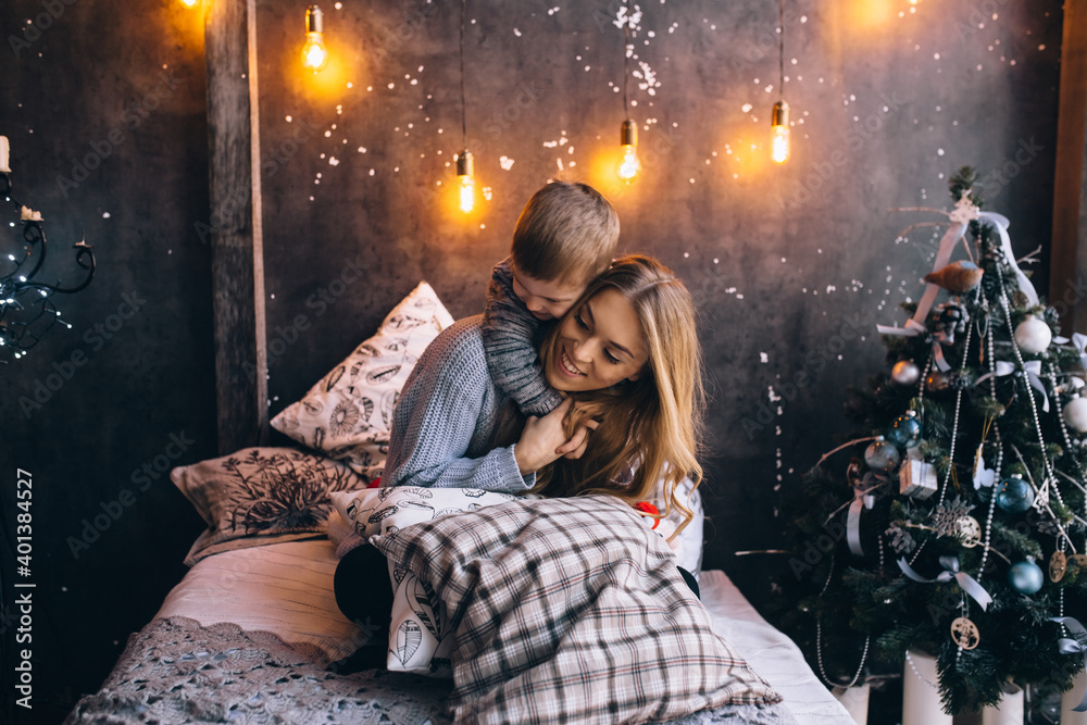 boy hugging his mother on the bed in the bedroom boy hugging his mother on the bed in the bedroom