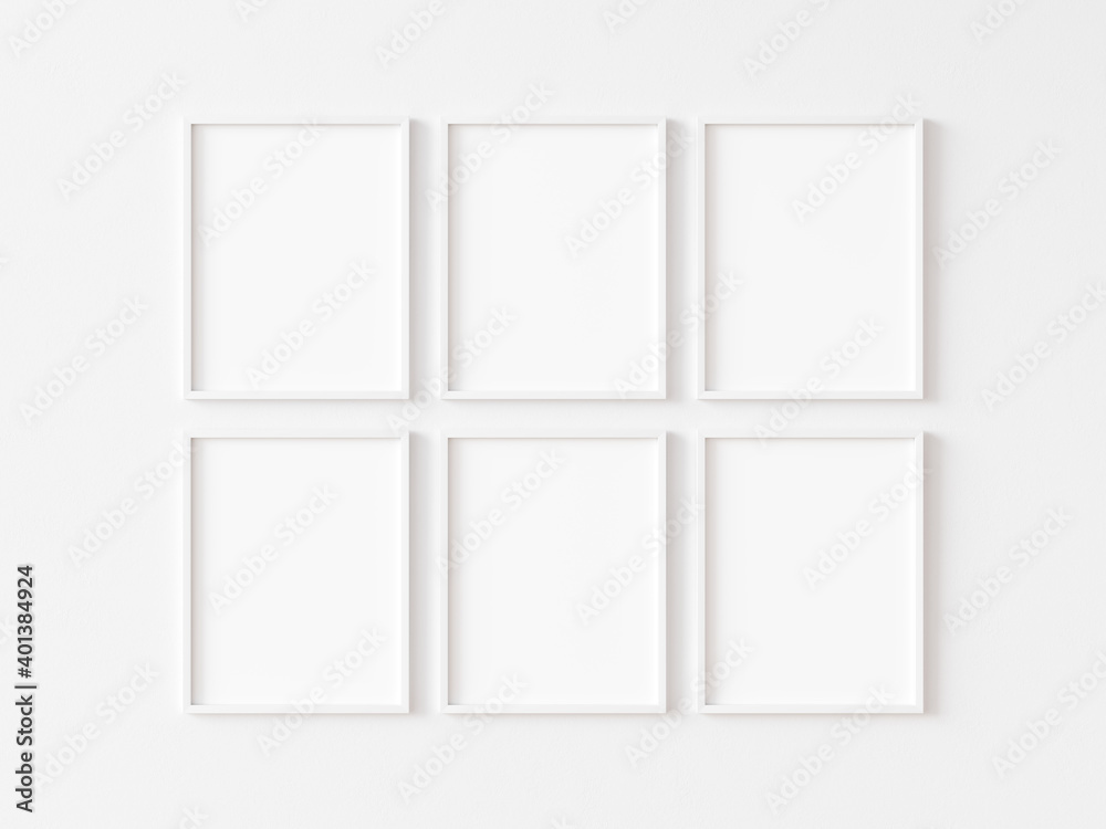 Six blank vertically oriented rectangular picture frames with thin white border hanging in two rows on white wall. 3D illustration.