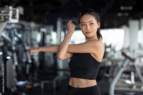 Young woman stretching at gym photo
