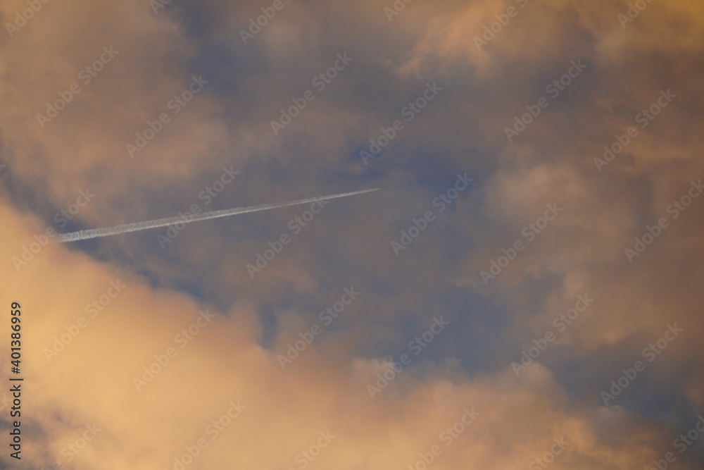 Plane pierces the clouds on a bright morning in Berlin Plane pierces the clouds on a bright morning in Berlin