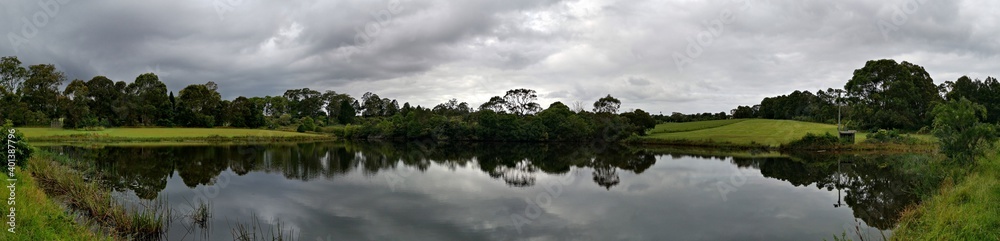 Beautiful panoramic morning view of a pond with reflections of trees and dark clouds on water, Fagan park, Galston, Sydney, New South Wales, Australia
Beautiful panoramic morning view of a pond with reflections of trees and dark clouds on water, Fagan park, Galston, Sydney, New South Wales, Australia