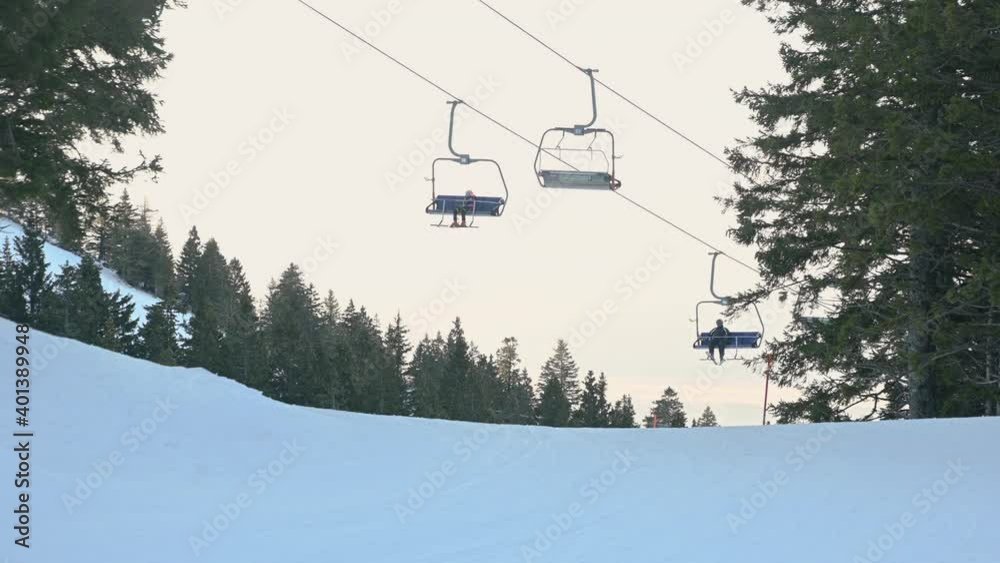 Ski lift for transportation skiers and snowboarders. Ski resort Kravavec, Slovenia. Ski elevator cableway for people transporting on winter mountain. Wide angle, static shot, real time Ski lift for transportation skiers and snowboarders. Ski resort Kravavec, Slovenia. Ski elevator cableway for people transporting on winter mountain. Wide angle, static shot, real time