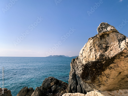 Rocky coastline, blue water, seascape background