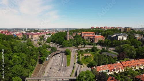 Aerial view above highway european routh e6 freeway lanes with residential red roofs houses around. Transportation concept shot at Sweden, Gothenburg. photo