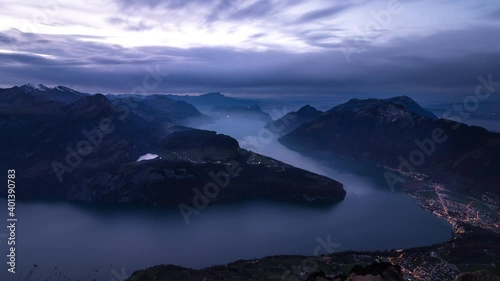 Day to night time lapse of Lake Lucerne as seen from Fronalpstock, Switzerland with a panoramic view of the fjords and mountain peaks photo