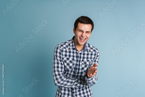 Portrait of happy smiling man isolated on blue