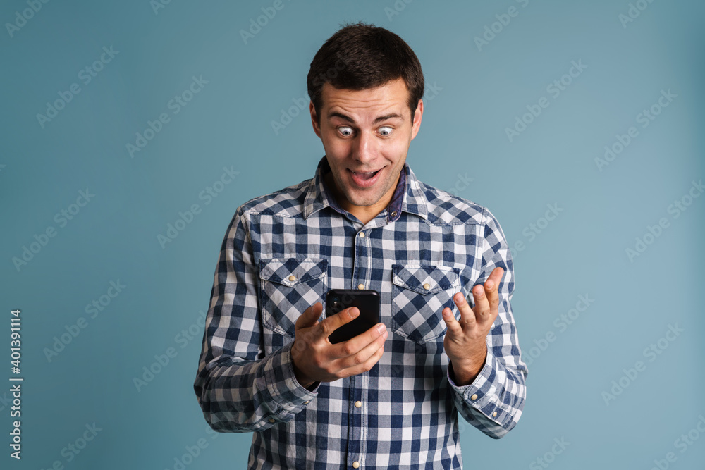 Handsome young man using mobile phone isolated